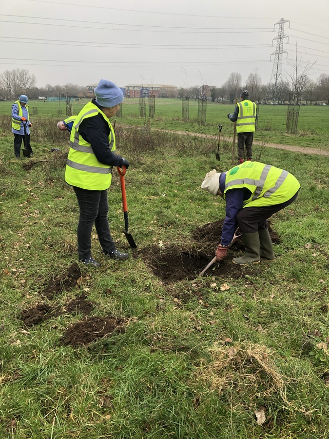 Shirley and Alison planting their tree